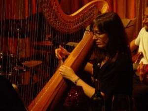 Carol Robbins plays pedal harp in recording session.