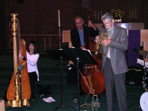 Carol Robbins plays pedal harp in recording session with bassist and flugelhorn player.