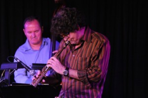 Darek Oles, bass, and Rob Lockart, alto sax, on stage playing.