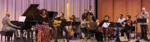 Billy Childs at grand piano leading Dianne Reeves (singing), Larry Koonse (guitar), Carol Robbins (harp), and other members of orchestra.